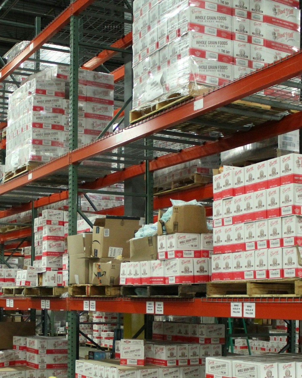 Warehouse racking stocked with labelled product cases