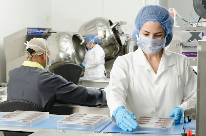 Inspectors reviewing product inside a food facility