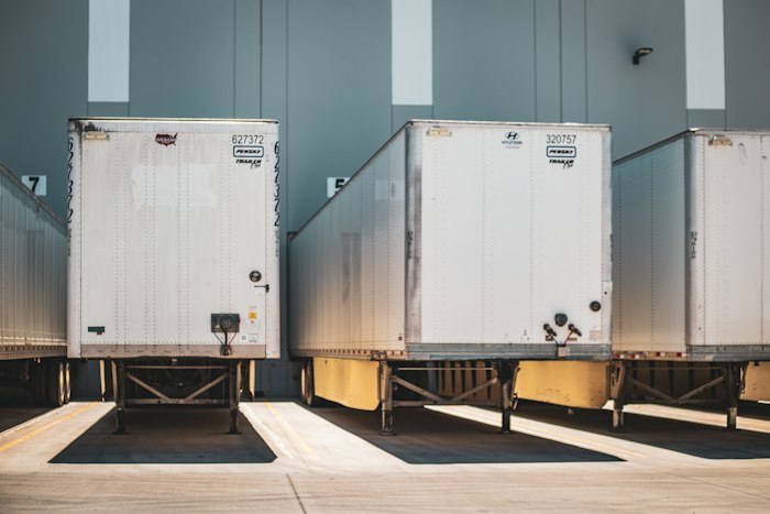 Row of refrigerated trucks at a distribution yard